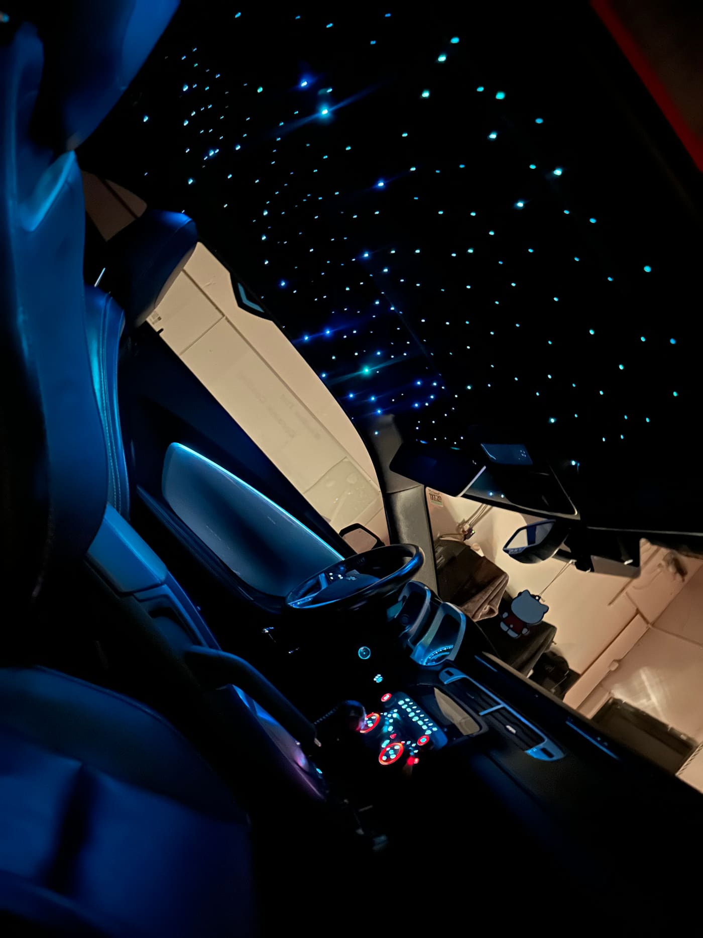 Ice-blue starlight headliner over blue leather seats in a Camaro