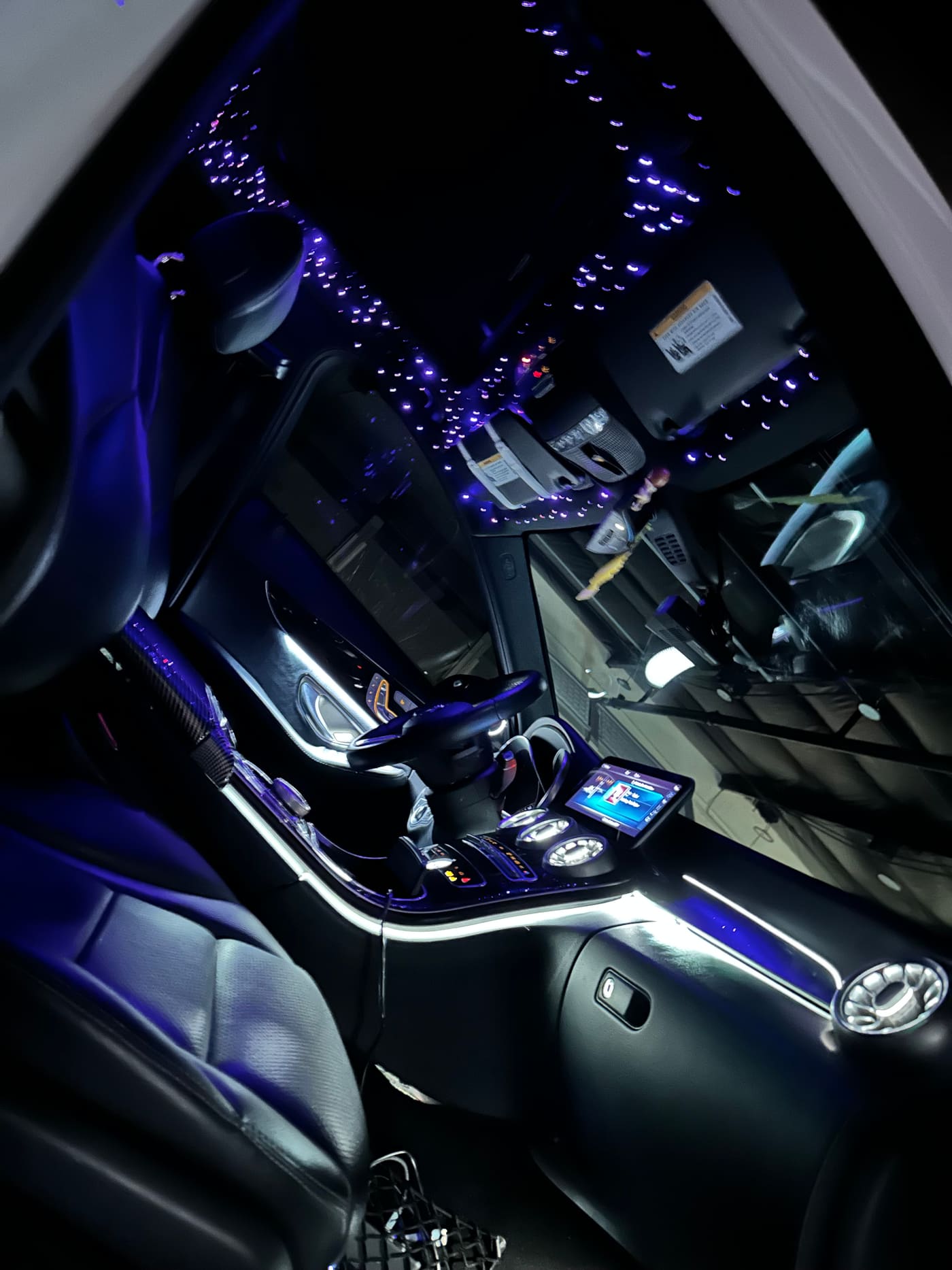 Lit center console trim with a starlight headliner above in a Mercedes